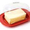 Butter on red butterdish on white background