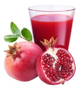 Pomegranate juice with pomegranate on a white background.