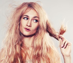 Young woman looking at split ends