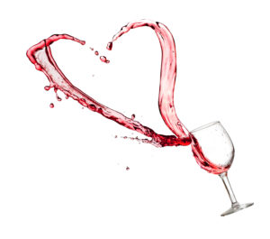 Heart splash from a glass of red wine isolated on white background