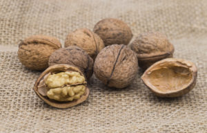 Image shows some walnuts on a jute bag